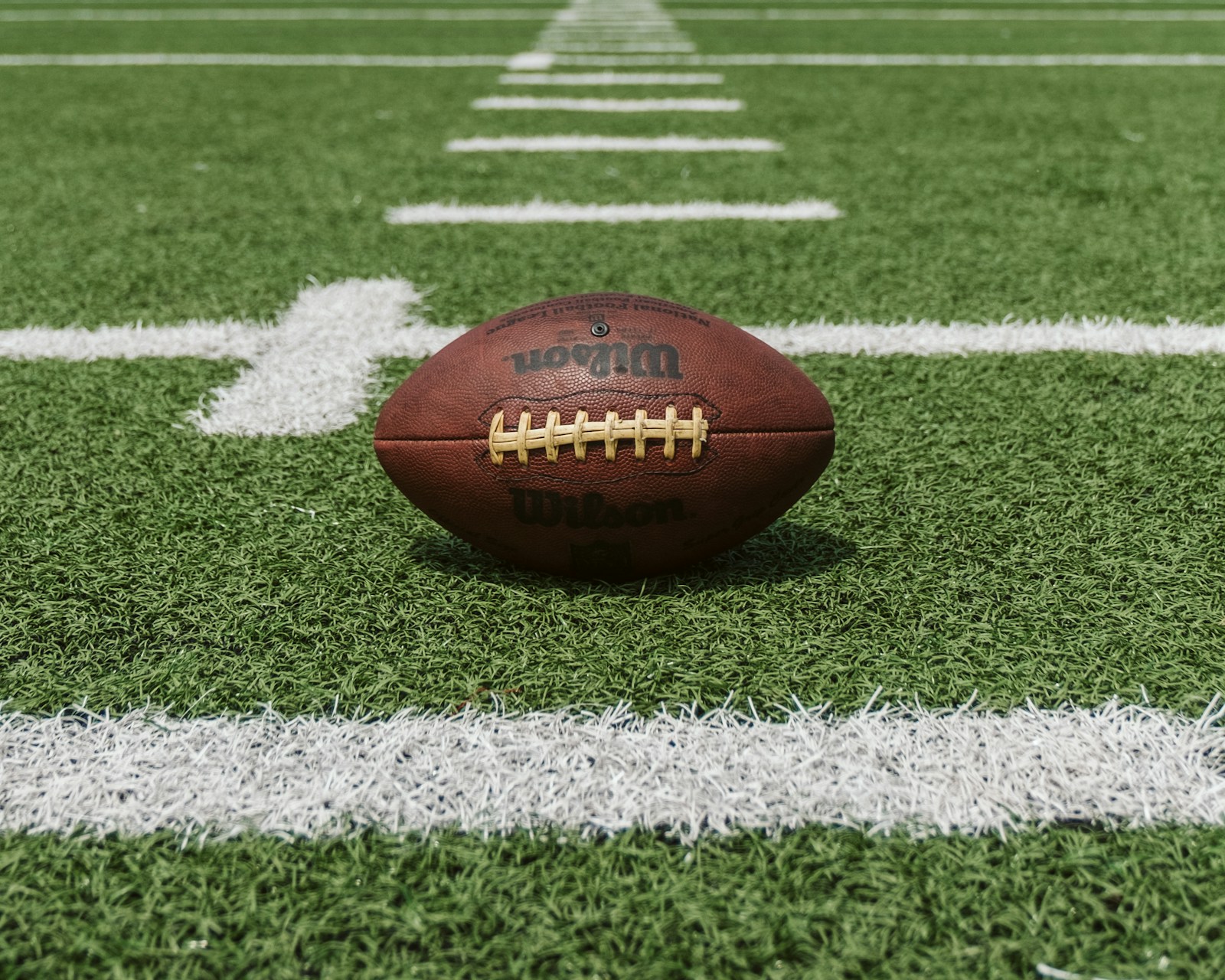 A football on a marked field, illustrative gridiron photography